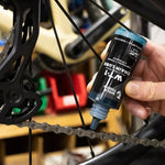 Wolf Tooth WT-1 Bike Chain Lube being applied to a chain
