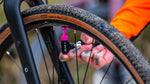 Muc-Off Road CO2 Inflator Kit being used to inflate a gravel tyre