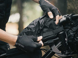 Integrated rain cover being put on the Topeak TopLoader bikepacking bag