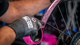 Muc-Off Tubeless Rim Tape being Installed on a Bike rim